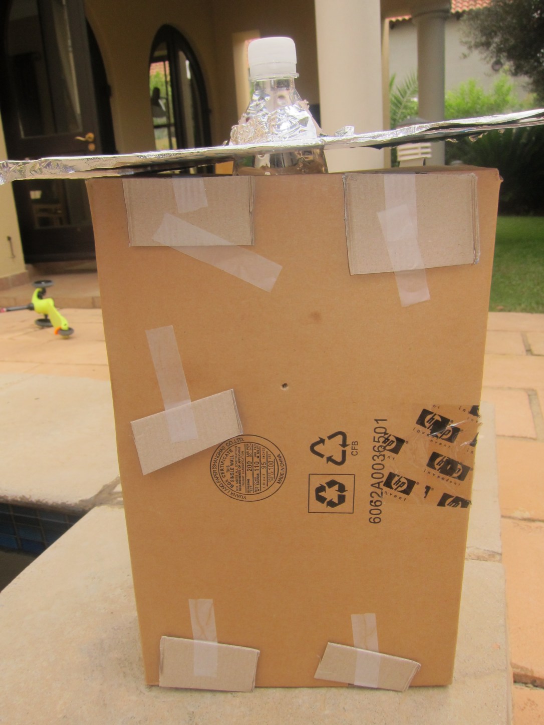 Large box and water bottle for liter of light kids science project.