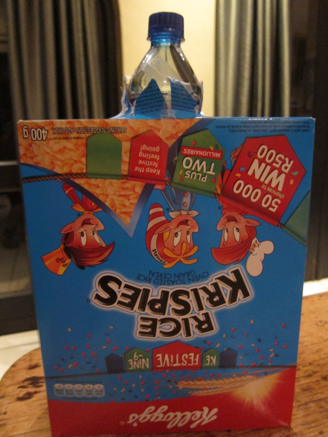 Bottle pushed through box in liter of light science project for kids.