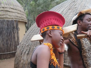 Here she is demonstrating the caring gift from her new husband.  A wooden pillow to keep her red hat on.