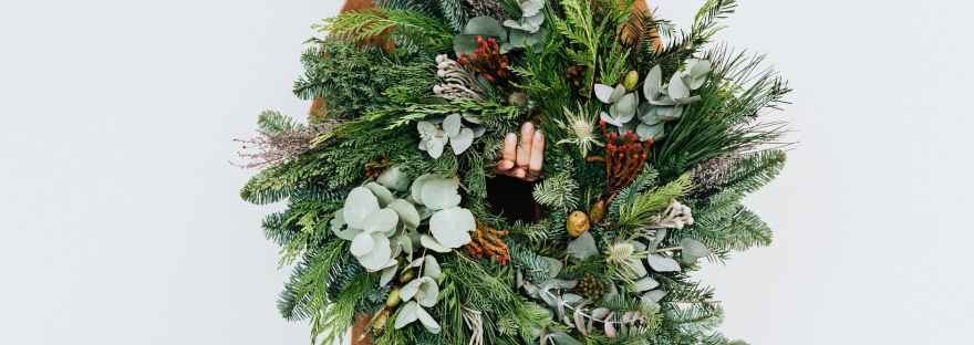 woman holding christmas wreath